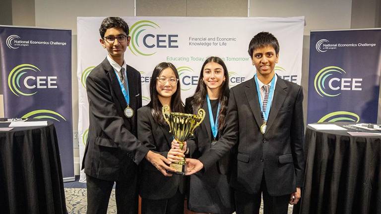 (L to R) Ronav Shah, Maile Meyoung Thung, Ivy Ponda and Mihir Kumar hold the National Economics Challenge trophy after winning the David Ricardo Division in Atlanta.