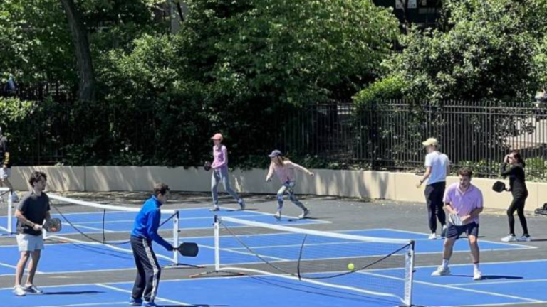 Albert, the man also known as “Dr. Pickleball” (in blue jacket) plays a doubles match at Carl Schurz Park