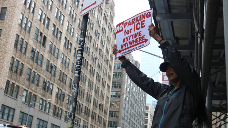 Protestors held up posters resembling no parking signs.