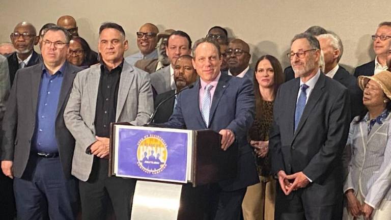 <b>Manny Pastreich (at mic) and Howard Rothschild (right of mic) surrounded by 32BJ Bargaining Committee the Realty Advisory Board members at New York Hilton Midtown. With only days before the old contract expired on April 20 and a strike loomed, a new contract was reached. </b>
