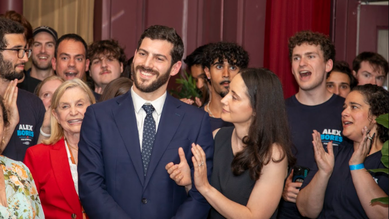 Alex Bores (center), wife Diane (right) and and many supporters on primary night June 23.