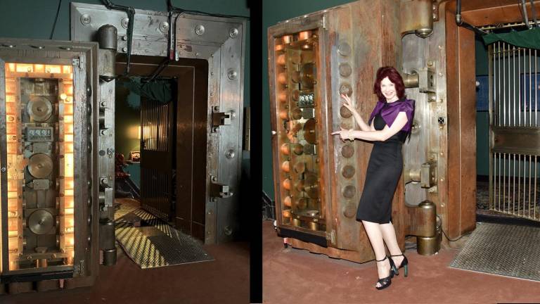Karen Rempel displays bank vault door’s thickness.